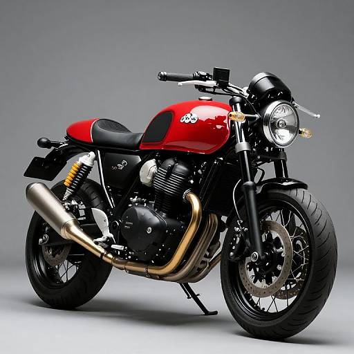 Photograph of a sleek, red and black retro-style motorcycle with a chrome exhaust, black seat, and round headlight, set against a gray background