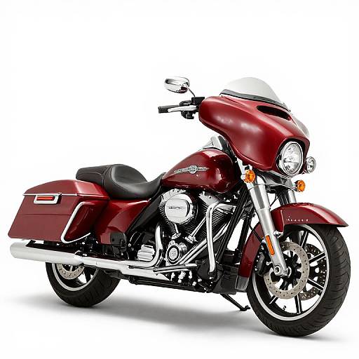 Photograph of a sleek, maroon Harley-Davidson cruiser motorcycle with chrome accents, black leather seat, and large sidebags on a white background