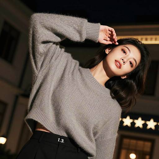 Stylish Woman Posing at Night Outside Luxury Hotel