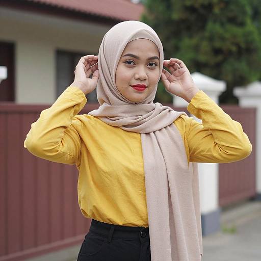 Outdoor Portrait of Asian Woman Adjusting Hijab