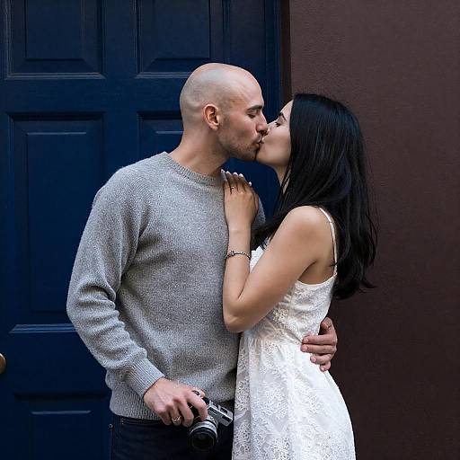 Bald Man Kissing Woman by Blue Door