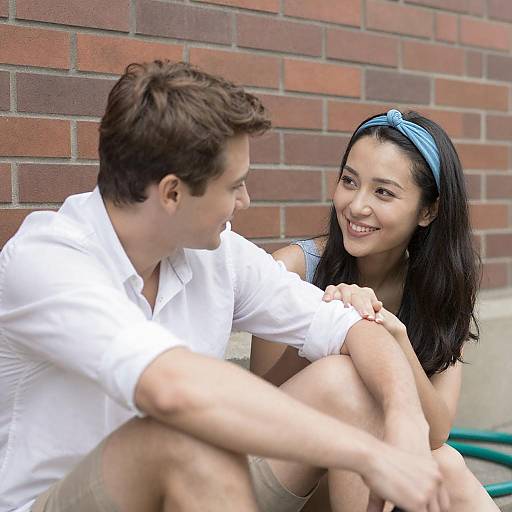 Couple Relaxing Against Brick Wall