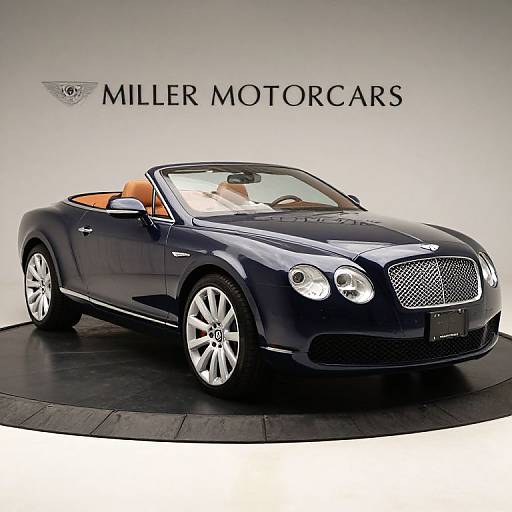 Photograph of a sleek, black Maserati convertible with orange leather interior, positioned on a circular black platform, against a white background with 