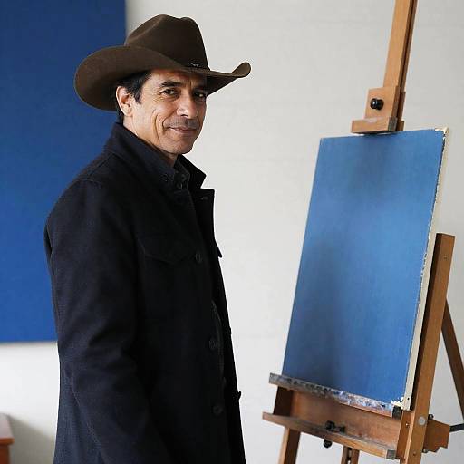 Middle-aged Man in Cowboy Hat by Blue Canvas