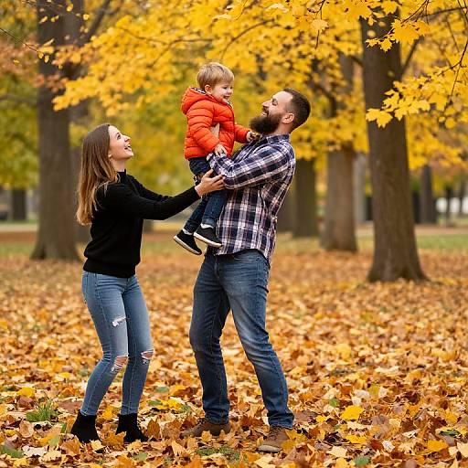 Photograph of a bearded father in a plaid shirt, carrying a smiling toddler in a red jacket, with a laughing mother in a black sweater