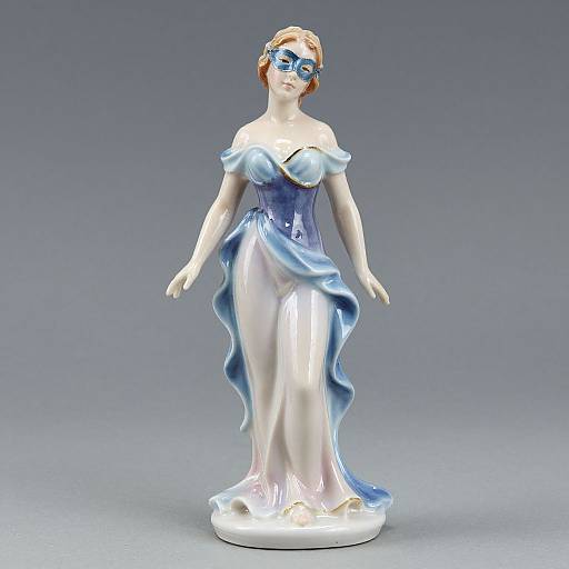 Photograph of a glass figurine of a fair-skinned woman in an off-shoulder blue and white gown, with blue glasses, standing against