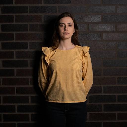 Dramatic Portrait: Woman by Brick Wall