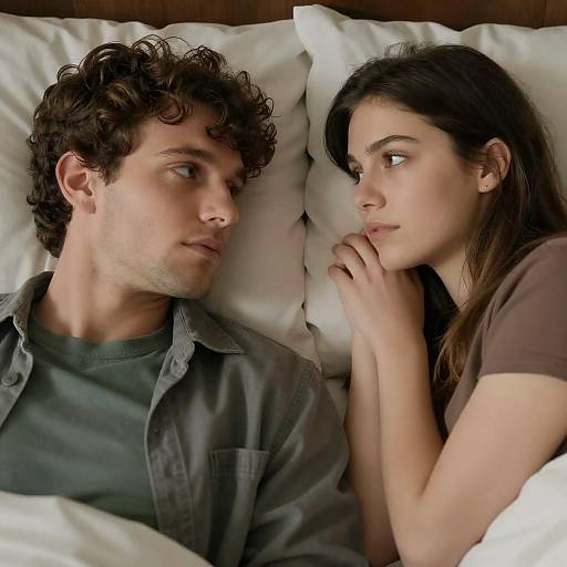 Couple Lying in Bed Looking at Each Other
