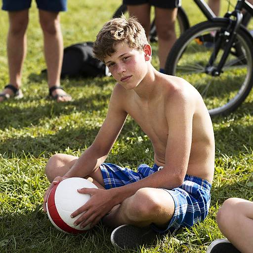 Teenage Boy Relaxing Outdoors with Ball