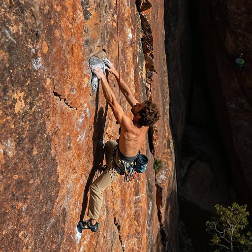 Sunlit Climber on Vibrant Orange Rock