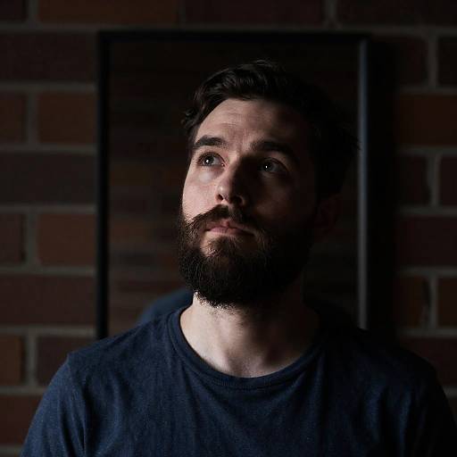 Thoughtful Bearded Man Against Brick Wall