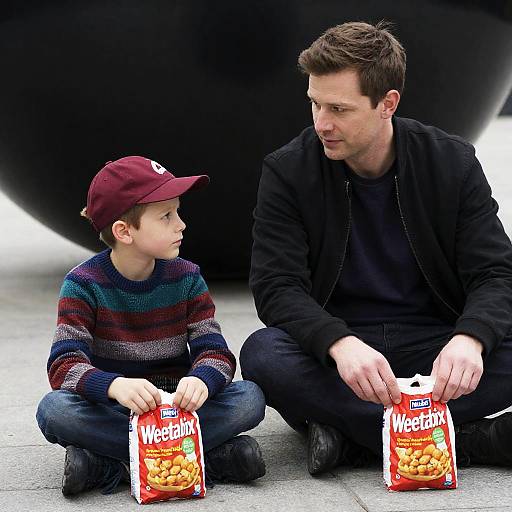Man and Boy Sitting with Weetabix Bags