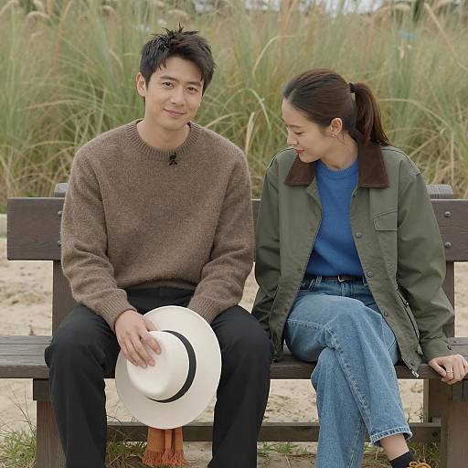 Asian Couple Sitting on Bench Outdoors