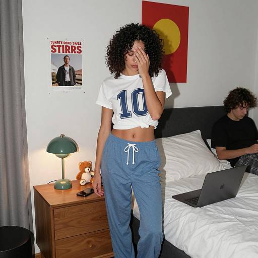Woman in Casual Pajamas by Nightstand in Bedroom