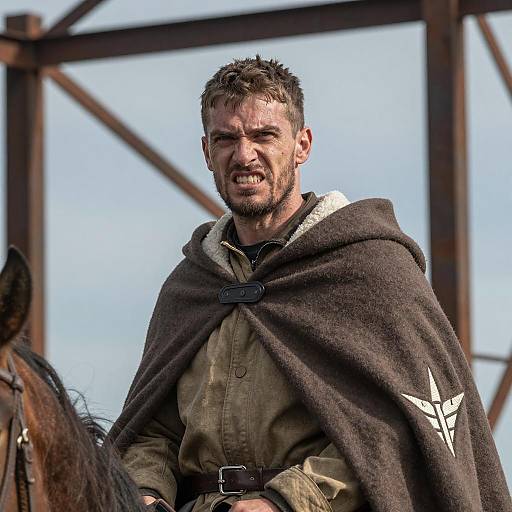 Rugged Man in Cloak Against Blue Sky