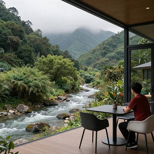 Glass-Walled Room Overlooking Forest River
