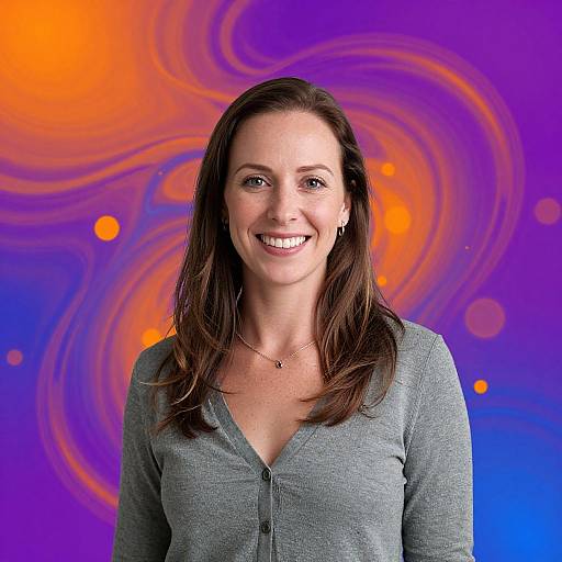 Photograph of a smiling woman with brown hair, wearing a gray V-neck cardigan, against a vibrant, swirling orange and purple background.