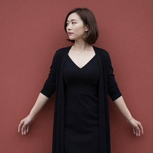 Elegant Woman in Black Against Red