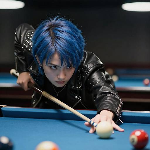 Photograph of a focused, blue-haired person with short hair in a black leather jacket, aiming a pool cue at a white ball on a blue pool