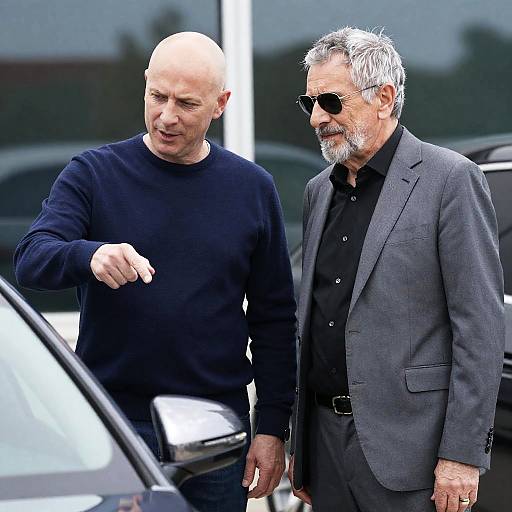 Photograph of Two Men by a Car