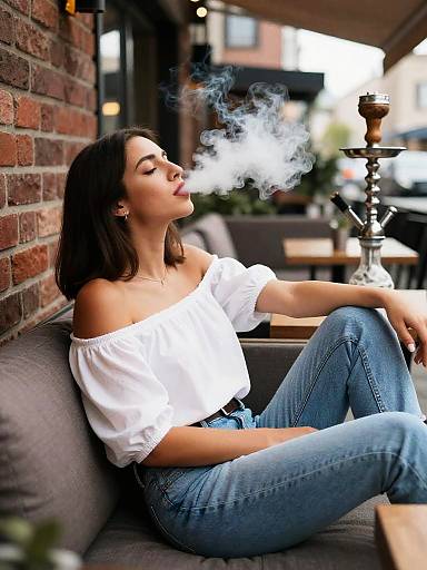 Woman Smoking Shisha on Outdoor Cafe Terrace