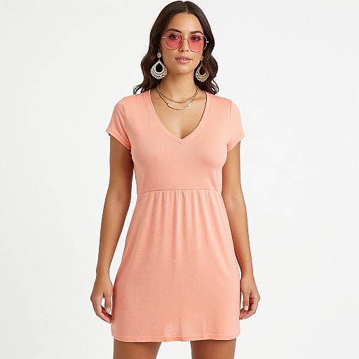 Photograph of a young woman with medium brown skin and black hair, wearing a pink V-neck short dress, pink sunglasses, and large hoop earrings,