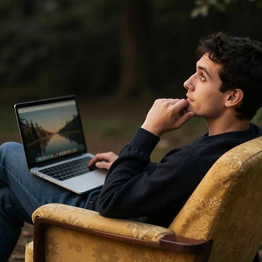 Curious Man in Floral Chair with Laptop