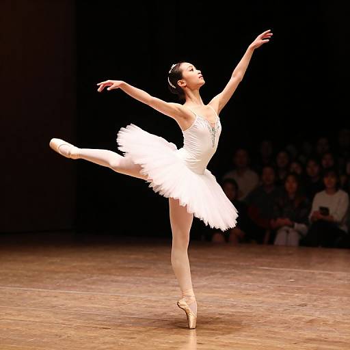 Photograph of a ballerina in a white tutu and pointe shoes, gracefully mid-leap on a wooden stage, with a dark background