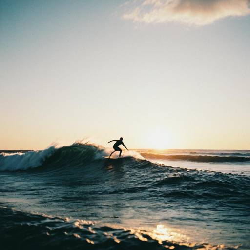 Surfer Catching Wave at Sunrise