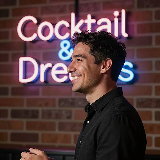 Smiling Man in Front of Neon Bar Sign