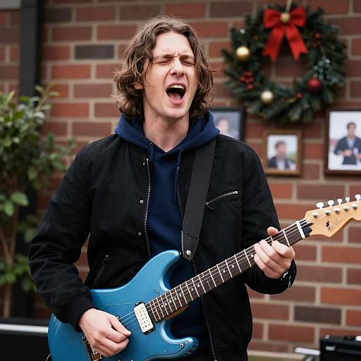 Man Singing and Playing Electric Guitar Outdoors