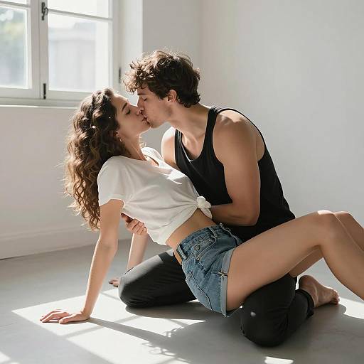 Couple Sharing a Kiss on Floor in Sunlit Room