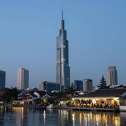 Modern Skyscraper by Waterfront with Outdoor Dining