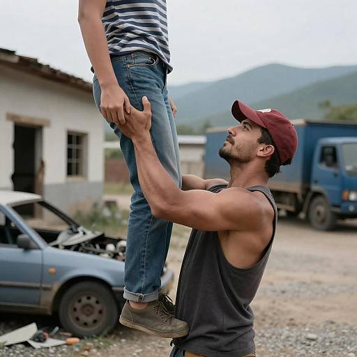 Muscular Man Lifting Person Outdoors