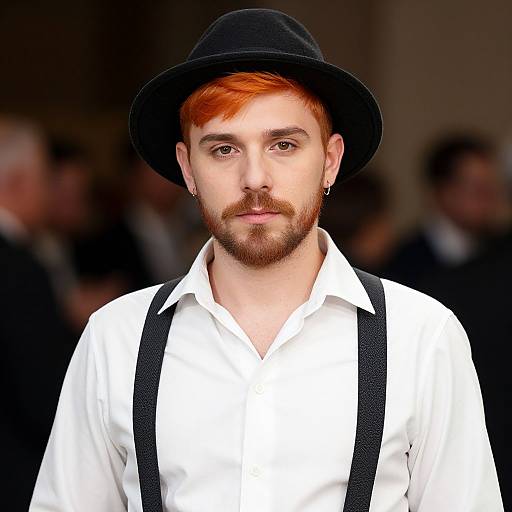 Photograph of a young man with red hair and beard, wearing a black hat, white shirt, and black suspenders, against a blurred dark background