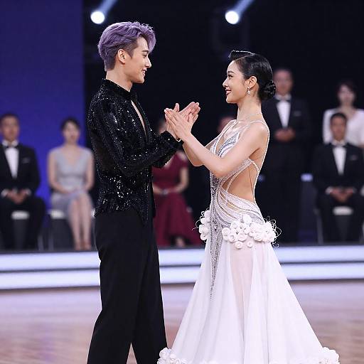Dancing Couple in Elegant Attire on Stage