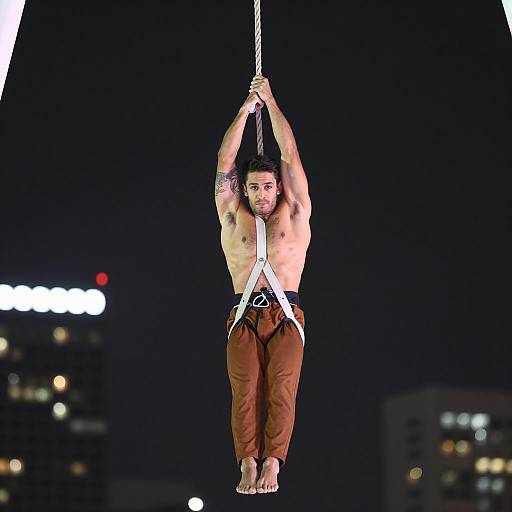 Intense Aerialist Performing at Night