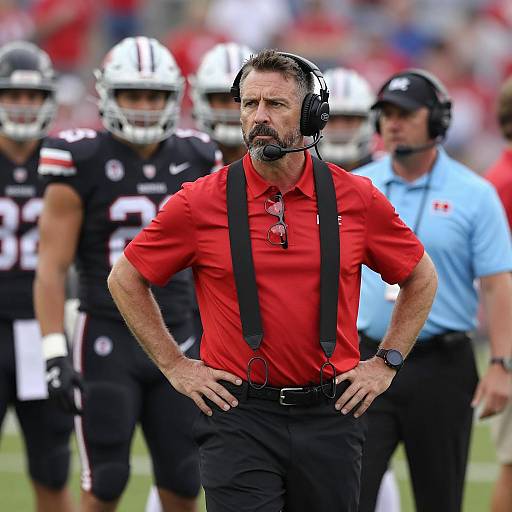 Intense Football Coach in Stadium Setting