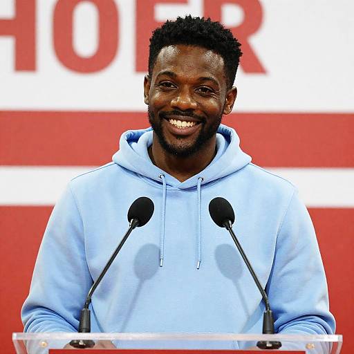 Smiling Man Speaking at Podium