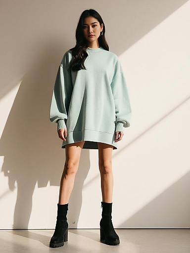 Asian Woman in Oversized Sweatshirt Dress with Black Ankle Boots