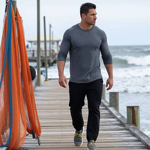 Muscular Man Walking on Weathered Pier
