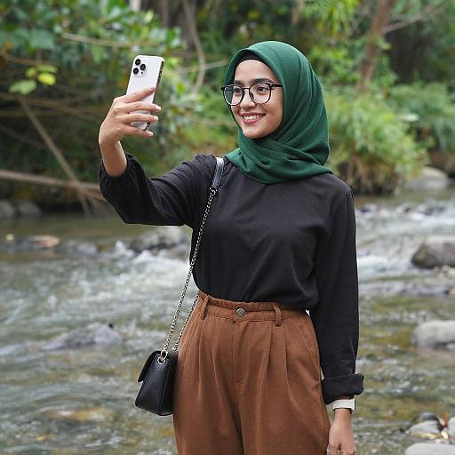 Smiling Woman Taking Riverside Selfie