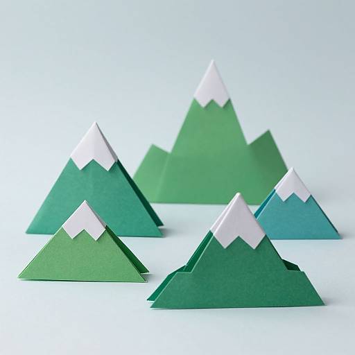 Photograph of five green paper mountains with white snowcaps, arranged in a diagonal row on a white background.