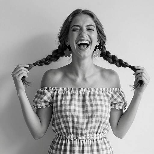 Laughing woman with braided hair in checkered dress