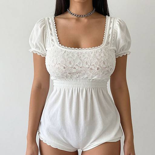 Photograph of a woman wearing a white, lace-trimmed, short-sleeve, peasant-style romper with a low-cut neckline, and