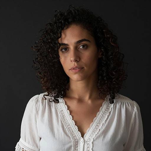 Portrait of Woman with Curly Hair in White Blouse