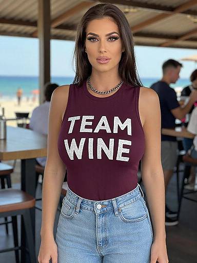 Photograph of a brunette woman with long hair, wearing a 