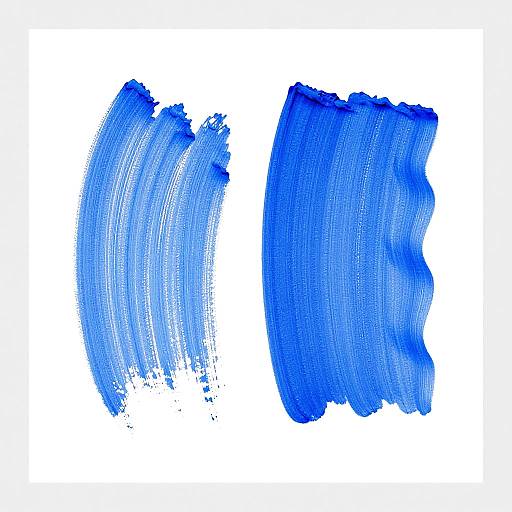 Photograph of two vibrant blue brushstrokes on white background. Left brushstroke is lighter, right brushstroke is darker. Textured, uneven edges