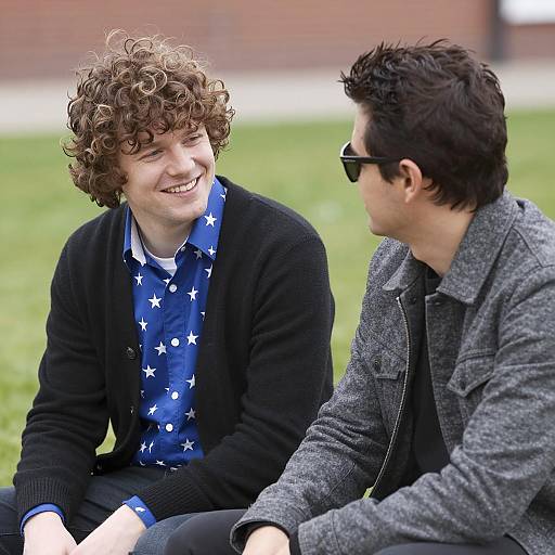 Two Men Sitting Outdoors Talking