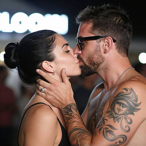 Passionate Tattooed Couple's Night Kiss
